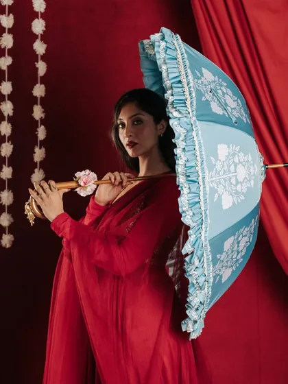 By introducing a contrasting color with this light blue umbrella, I created a visually striking image that stands out within the series. The pose highlights the product's structure and ruffled edges, providing a clear view for potential customers.