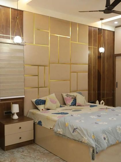 Another angle of the luxurious beige and gold bedroom, showing the wardrobe and the overall warm ambiance.