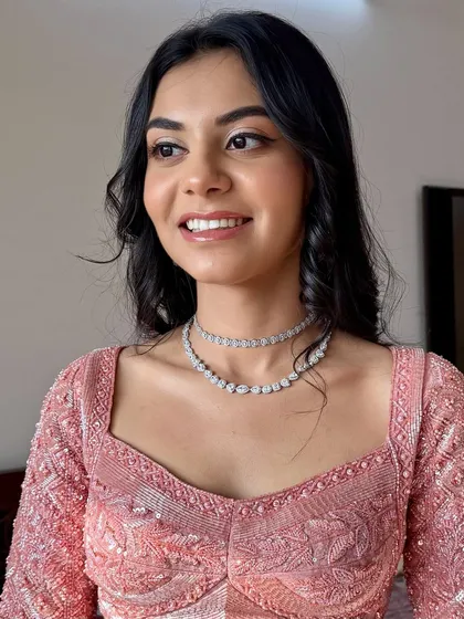 A side profile showing the soft, glowing makeup. The look is modern, elegant, and perfect for any celebration.