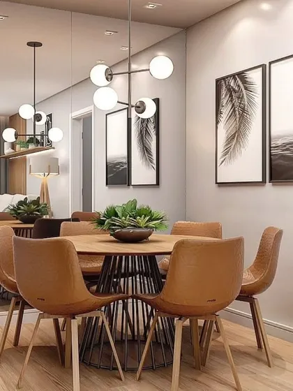 A stylish dining area with tan leather chairs and a round wooden table. The large mirror on the wall enhances the sense of space.