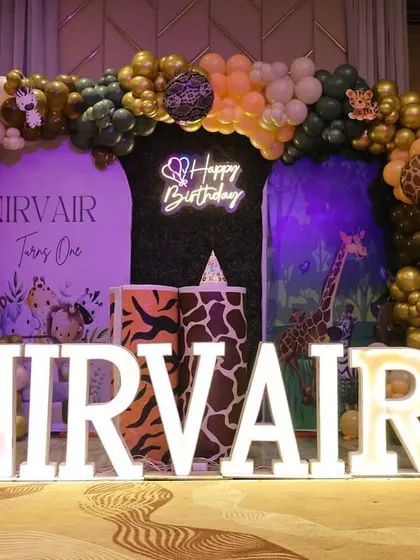 This angle shows the full "NIRVAIR" marquee letters and the '1' light-up number, which are key focal points for birthday photos.