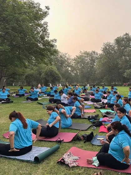 A large outdoor gathering for International Yoga Day. Practicing together in nature brings a special kind of peace and energy.