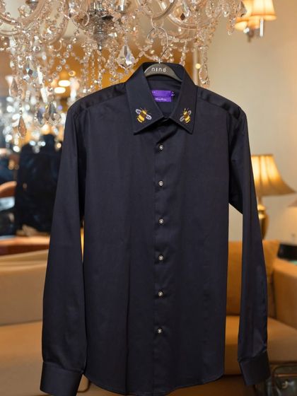 Even a simple shirt can become a piece of art. This dark formal shirt features our signature bee embroidery on the collar, a small detail that makes a big impact.