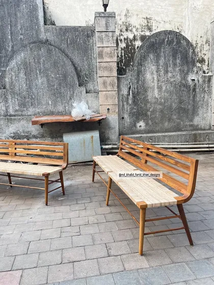 A pair of teak benches with woven seats, inspired by classic mid-century designs.