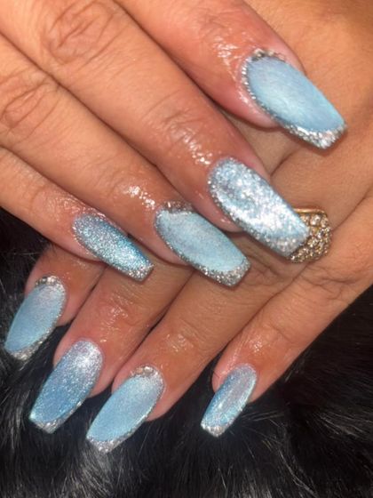 An icy blue glitter set with a sparkling silver glitter fade at the tips.