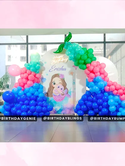 A closer look at the balloon arch and custom backdrop for the Little Mermaid party, showing the personalized details.
