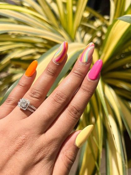 I can’t stop fussing over these gorgeous summer nails. They feature a mix of solid bright colors and a wavy rainbow design.