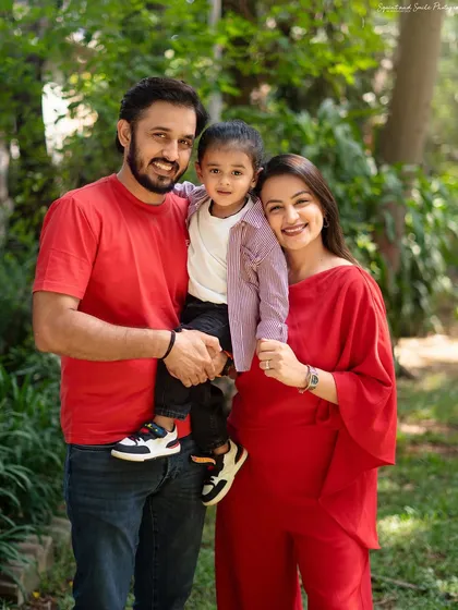 A lovely standing portrait from an outdoor family photoshoot. The natural setting and bright colors make this a vibrant and happy memory.
