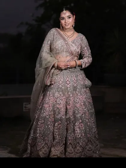 A confident pose from a happy client in our popular grey and pink rental lehenga.