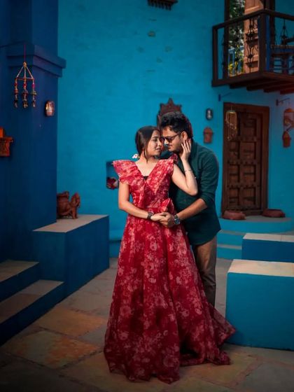 A sweet, intimate moment from the same shoot, showing how the floral gown adds softness and color to the couple's portraits.