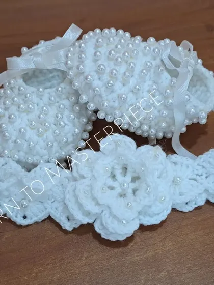 A full view of the pearl-embellished booties and headband set, a beautiful and complete accessory package for a baby's christening.