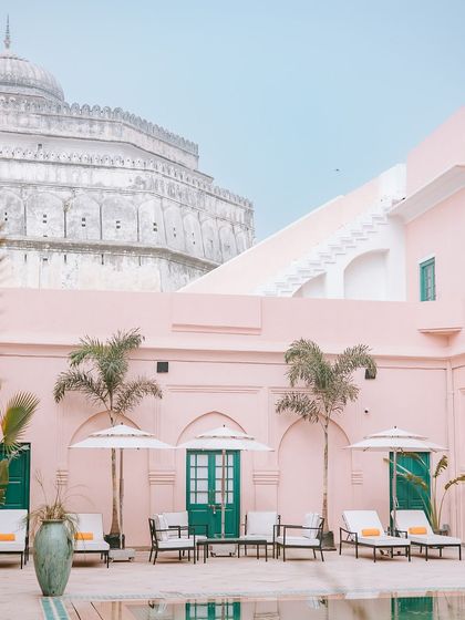 The stunning pink architecture and tranquil pool of Ranbaas The Palace in Patiala, a perfect example of a heritage venue that blends history with modern luxury.