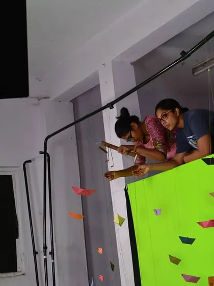 Our puppeteers working above the green screen set, carefully manipulating the puppets for a video project.