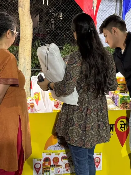 A couple checking out products at a food brand's stall. Our exhibitions offer a multi-sensory experience for visitors.