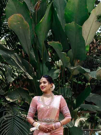 A stunning bridal portrait against a backdrop of our tropical plants. The scale of the leaves adds a dramatic and exotic feel to the photo.