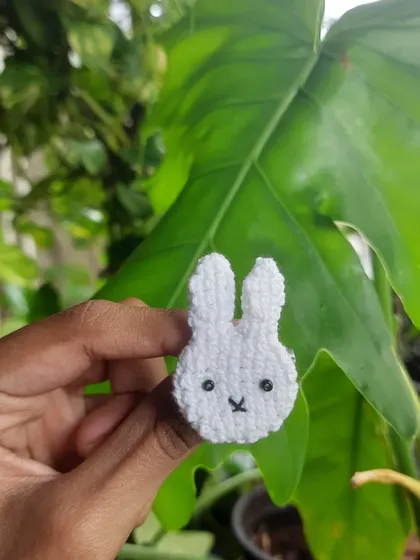 A close-up of the Miffy pin, perfect for fans of the classic character. The simple, clean design is made with tight, neat stitches.