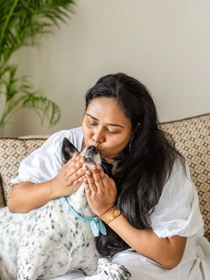 A mother's gentle kiss for her beloved dog, Yuki. This intimate, close-up shot highlights the deep affection and quiet moments that define the human-animal bond.