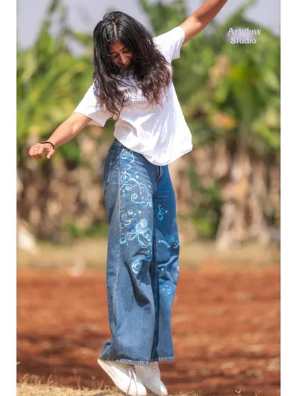 A joyful jump in my custom-painted jeans. Wearable art should be fun and make you feel free.