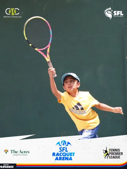 Reaching high for an overhead smash. We teach our young players to be aggressive and confident in every aspect of their game, turning defensive plays into offensive opportunities.