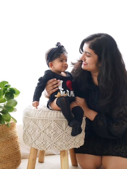 A mother and daughter share a sweet look. The daughter's "I ❤️ Mama" onesie makes this an extra special portrait.