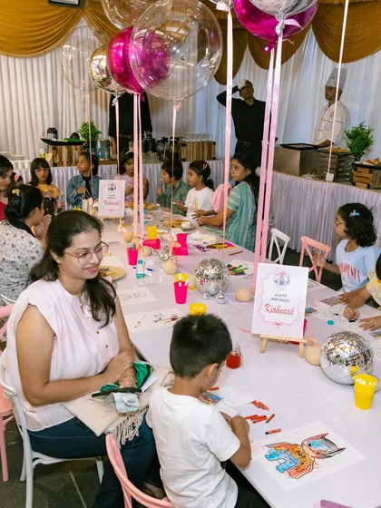 A beautiful shot of the dining setup at a princess party, with long tables decorated with art supplies for a creative activity.