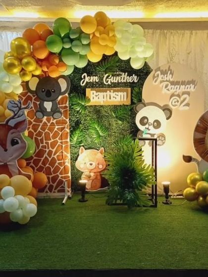 A cute animal-themed baptism and 2nd birthday celebration, featuring a variety of friendly animal cut-outs and a vibrant balloon arch.