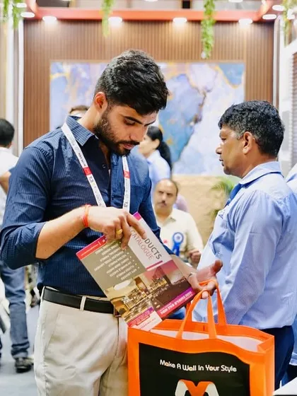 An attendee browsing our catalog, with our branded tote bag in hand. We made sure our visitors had something to remember us by.