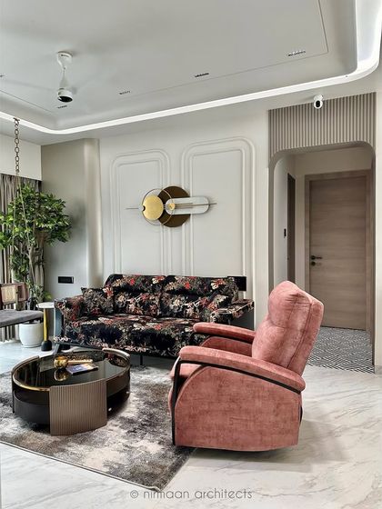 A comfortable pink recliner adds a pop of color and a cozy corner for relaxation in the 'Atmosphere' living room. We focus on creating spaces that are not just beautiful but also incredibly comfortable.