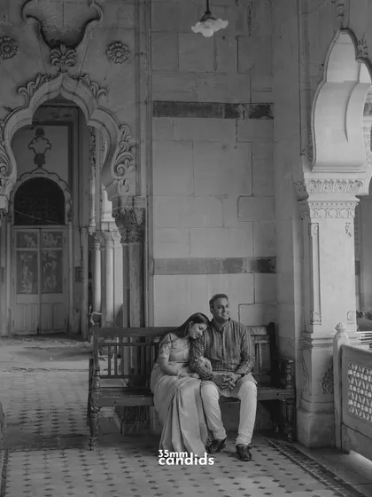 A quiet, intimate moment shared on a bench within the palace corridors. This black and white photo captures a timeless, serene feeling of togetherness.