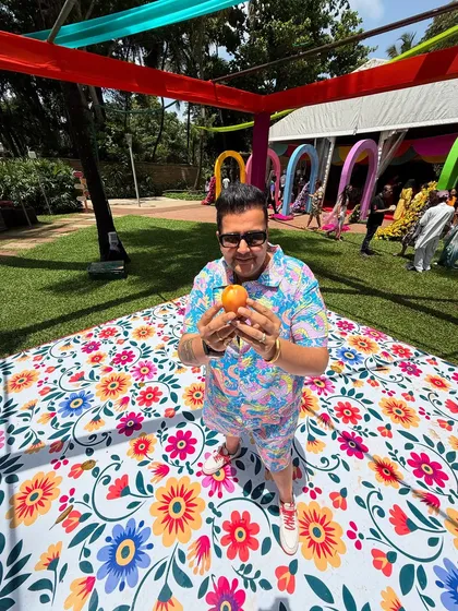 Holding a tomato at the Tomatina-themed party in Goa. It's all about embracing the theme and having fun.