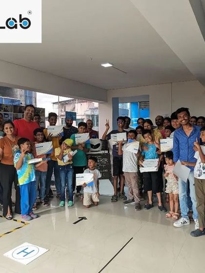 The whole team together! This photo captures the vibrant community of students, parents, and mentors after a successful Robotic Challenge event, celebrating a day of innovation and learning.