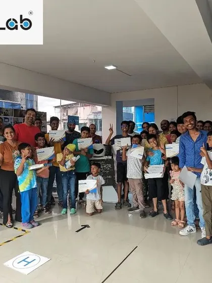 The whole team together! This photo captures the vibrant community of students, parents, and mentors after a successful Robotic Challenge event, celebrating a day of innovation and learning.