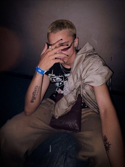 A candid, moody shot from a night out. It reflects the introspective side of my personality and the dark, atmospheric quality you'll find in my techno and psytrance music.