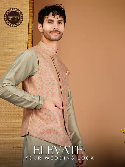 Elevate your wedding look. A peach-toned patterned Nehru jacket over a grey kurta, perfect for a sangeet or engagement.