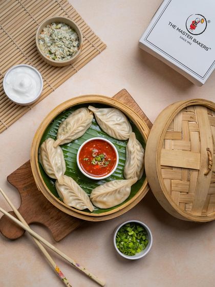 Another look at our classic steamed momos, arranged neatly in a circle. Each dumpling is carefully folded to hold in the juicy filling.