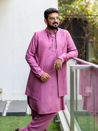 The ‘Pink Pathani’ suit, customized in lotus stem fabric. This conscious alternative to silk features modern, minimalistic embroidery, perfect for those who wish to inspire mindful living.