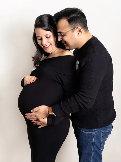 A classic portrait celebrating the beautiful shape of a mother to be. Dressed in timeless black, this couple shares a joyful, loving moment. My studio sessions are perfect for creating these clean, emotion filled images.
