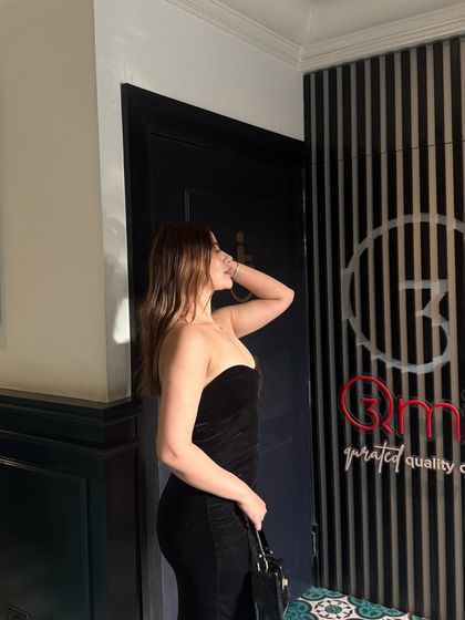 A strapless black velvet dress, a timeless and sophisticated choice for any evening event.