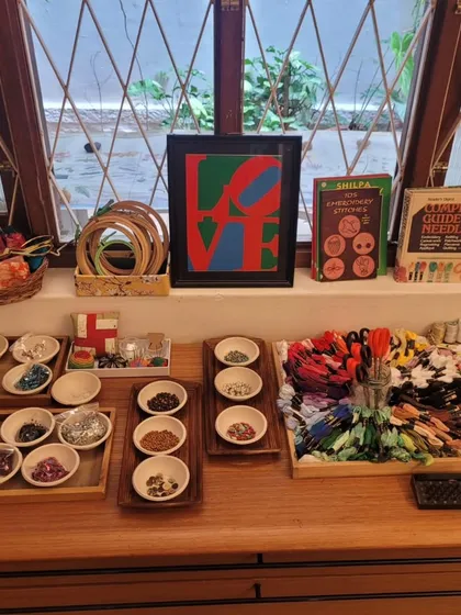 A beautifully arranged tray of sewing and embroidery materials. We believe that presenting materials with care and beauty inspires children to treat them with respect and engage with the work more deeply.