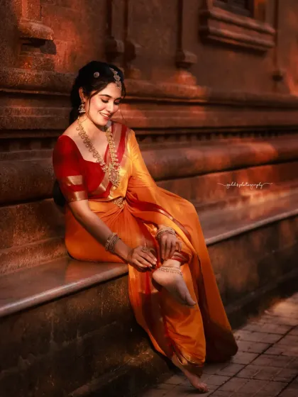 This portrait captures the bride in a relaxed pose, her bare feet adding a touch of groundedness and connection to the earth. The lighting is soft and beautiful.
