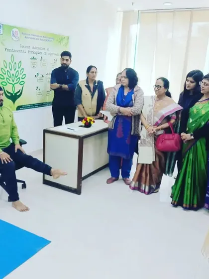 Demonstrating chair yoga exercises during a Yoga & Ayurveda Health Camp for NTPC. These simple movements can be easily incorporated into the workday to relieve stiffness.