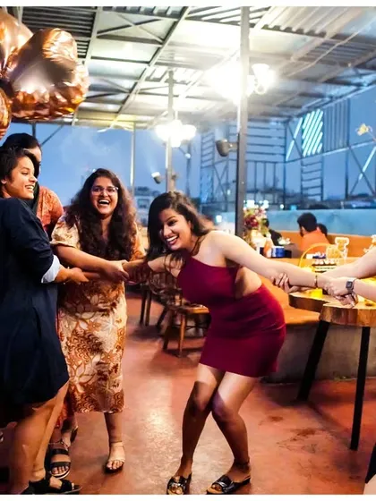 Pure joy and fun at a bachelorette celebration. Friends playfully pull the bride-to-be, laughing and creating a memory that will last forever.