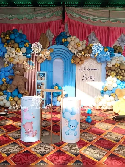 The complete stage setup for the twins' welcome party, featuring two teddy bears, themed pedestals, and "BABY" blocks.