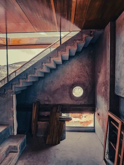 Even during its construction, the soul of the space was apparent. The raw concrete walls and unfinished stairs captured the light and framed the mountain views, showing the strong bones of the design before the final layers were added.