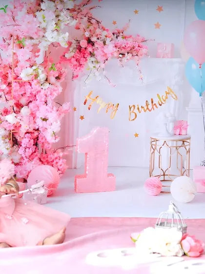 Holding a magic wand, this birthday girl is ready to make a wish. The wide shot shows the full, enchanting pink floral setup I created in the studio.