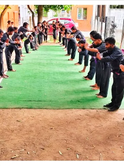Students bow in respect before beginning their Brown and Black Belt test. This gesture is a fundamental part of martial arts, signifying humility and respect for the art and each other.