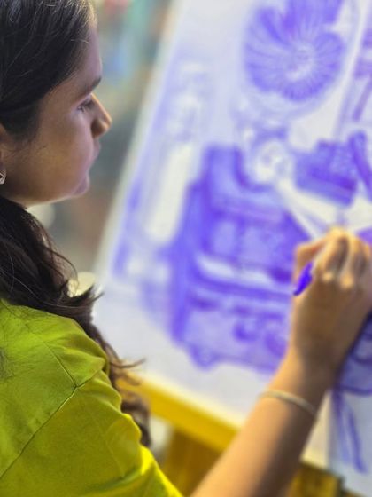 A student fully engaged in her artwork, using a ballpoint pen to create depth and shadow. Our classes provide a focused environment for artists to hone their craft.