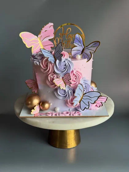 A full view of the pink and lavender butterfly cake for Shloka. The colors blend beautifully, creating a soft and elegant ombre effect.