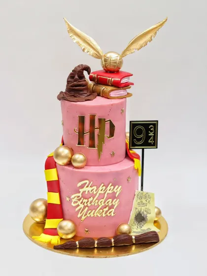 A magical two-tier Harry Potter themed cake, perfect for any fan's birthday. This design combines several techniques you can learn, including working with fondant, creating iconic elements like the Golden Snitch and Sorting Hat, and achieving a polished, professional look.