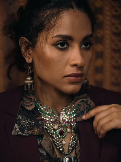 A portrait that highlights both the jewellery and the subject's elegant profile. The composition draws the eye across the details of the necklace.
